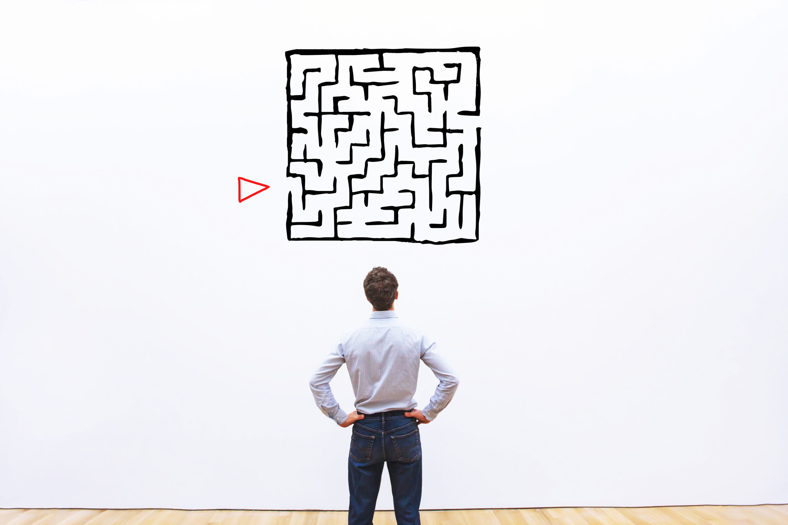 Man looking at maze with start position labelled